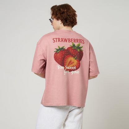 Back view of a dusty pink oversized tee featuring a vintage-style strawberry graphic print with "Strawberries Too Sweet For You" text.