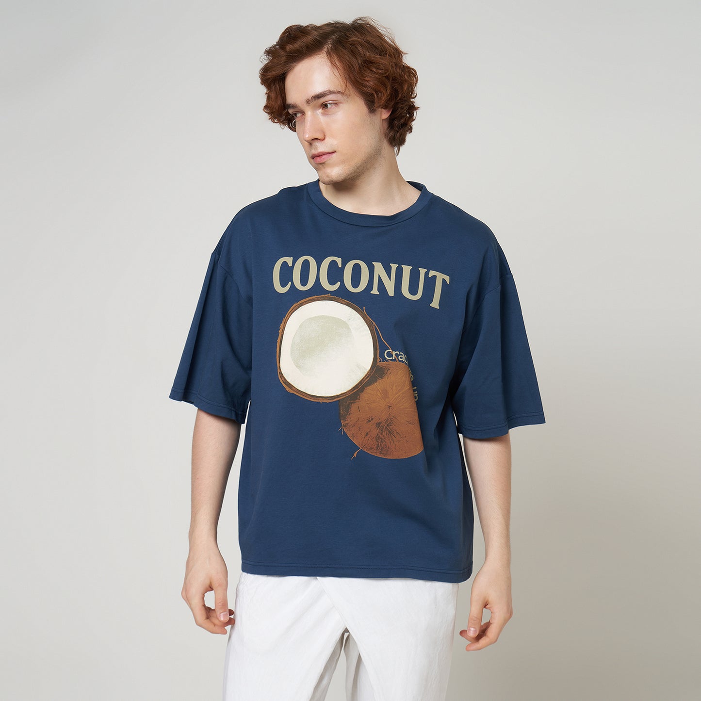 Front view of a model wearing the Stargazer blue boxy tee, highlighting the relaxed drop-shoulder fit and coconut graphic.