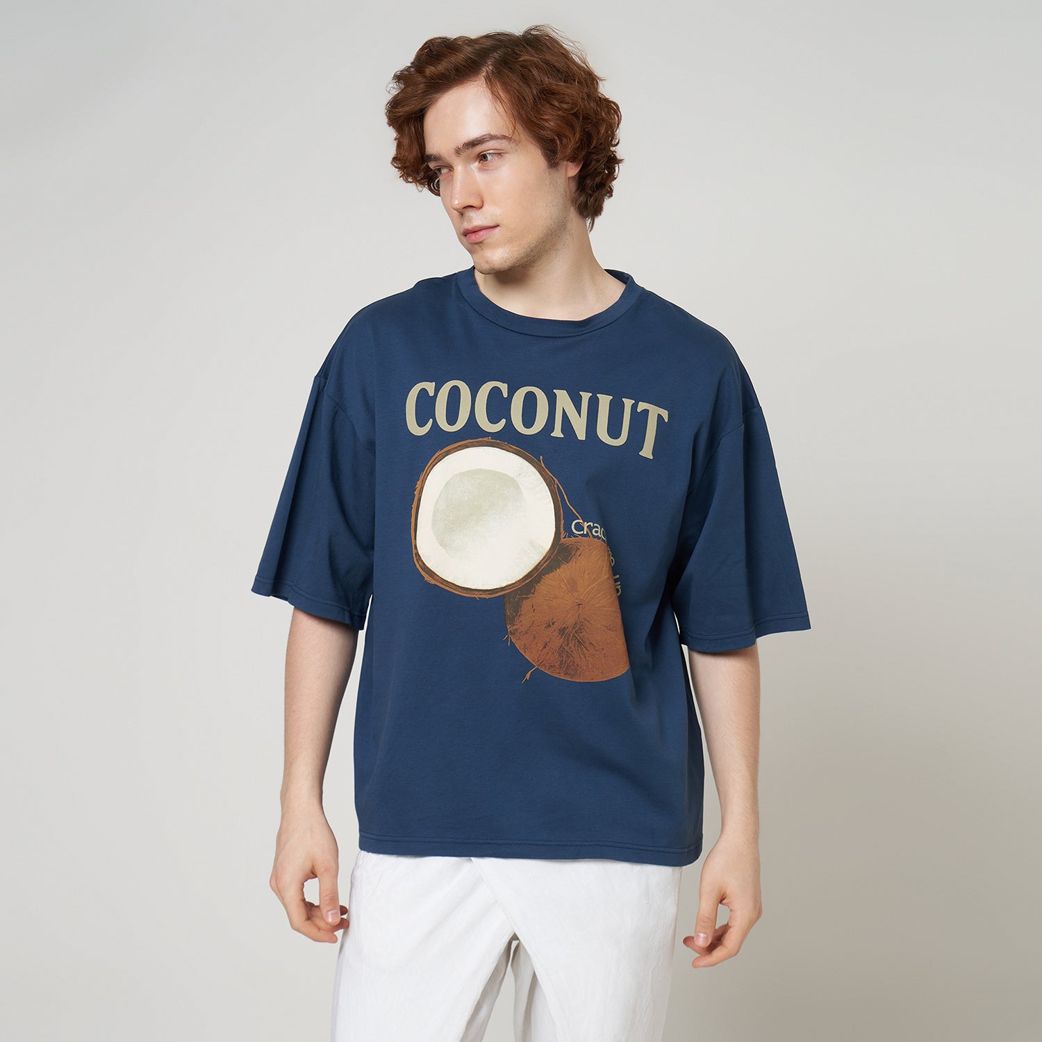 Front view of a model wearing the Stargazer blue boxy tee, highlighting the relaxed drop-shoulder fit and coconut graphic.