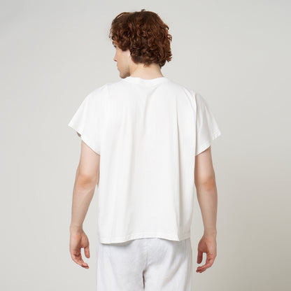 Rear view of the VERBO white cropped tank on model highlighting the relaxed drape and wide cap-sleeve style.