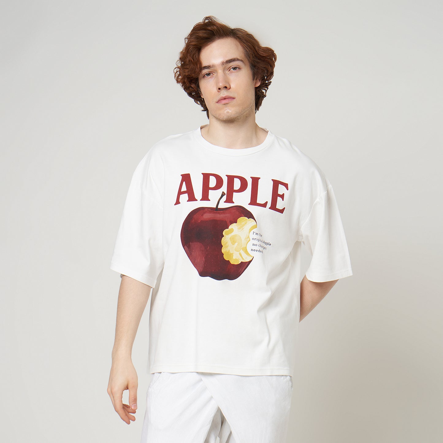 Side profile of the Broken White Apple Tee on model, highlighting the drop-shoulder seams and relaxed boxy silhouette.
