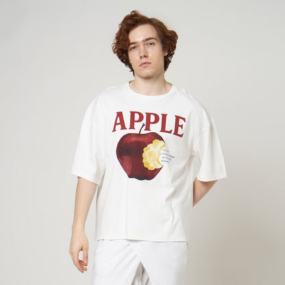 Side profile of the Broken White Apple Tee on model, highlighting the drop-shoulder seams and relaxed boxy silhouette.