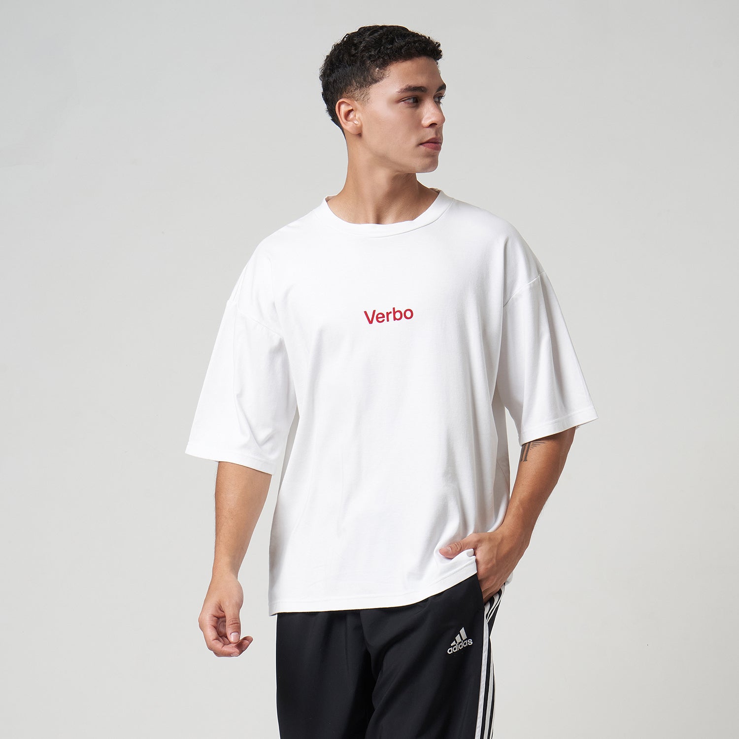 Three-quarter view of the VERBO Flocking Boxy Tee in Broken White, a modern streetwear-inspired navy blue t-shirt.
