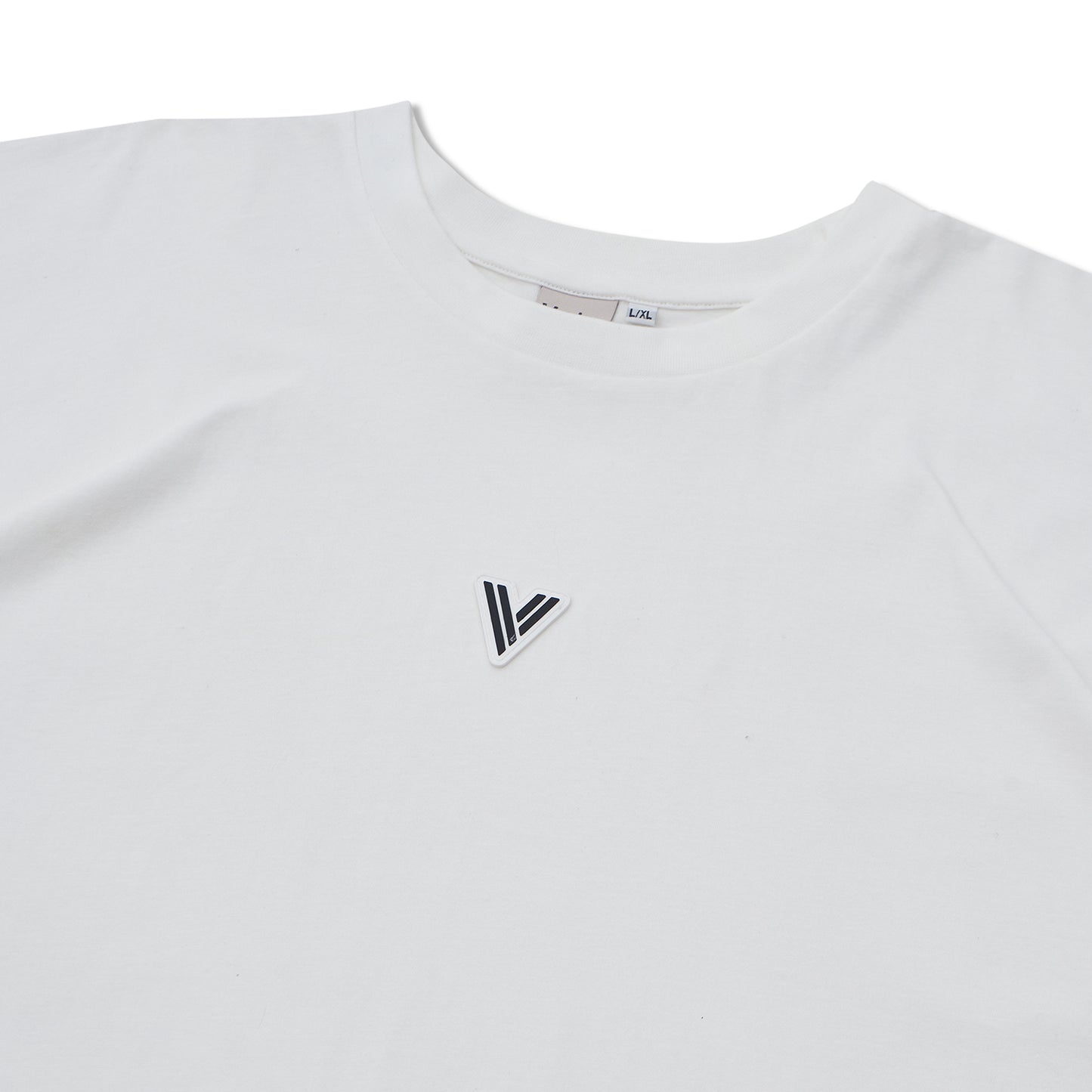 Close-up of the VERBO white tank neckline with brand tag and high-quality white patch V logo detail.