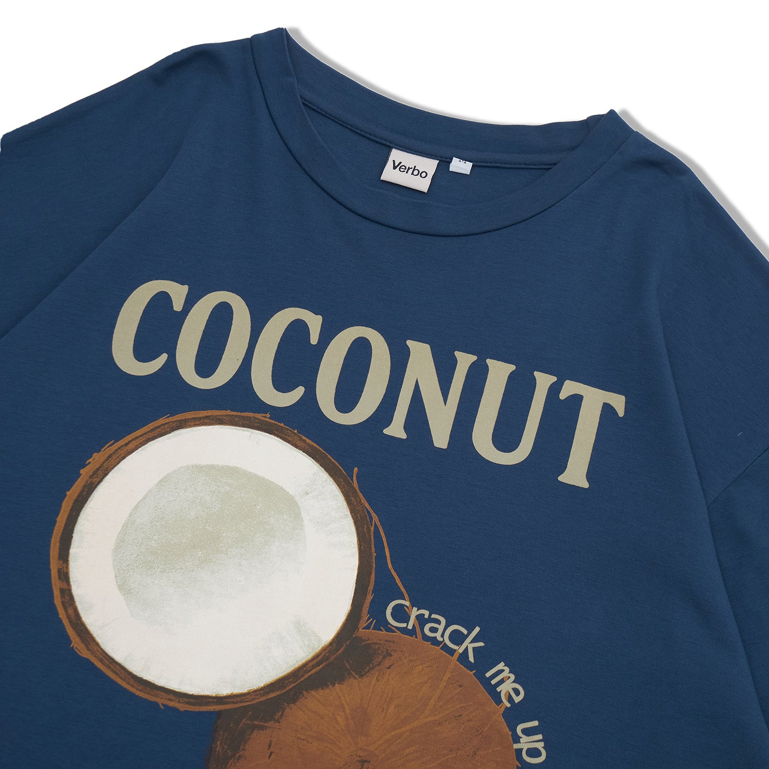 Detailed view of the "COCONUT" graphic and "crack me up" text on the Stargazer blue cotton fabric.